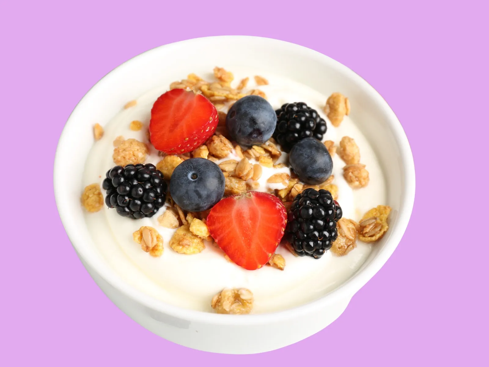 Overhead flat lay of a CD Yogurt cup topped with fresh berries and granola