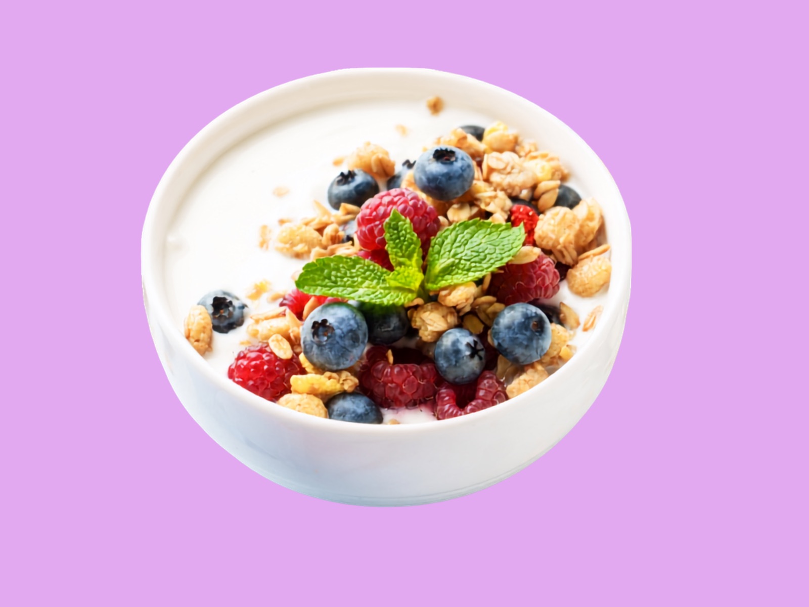 A CD Yogurt cup piled high with fresh raspberries, blueberries, granola and mint